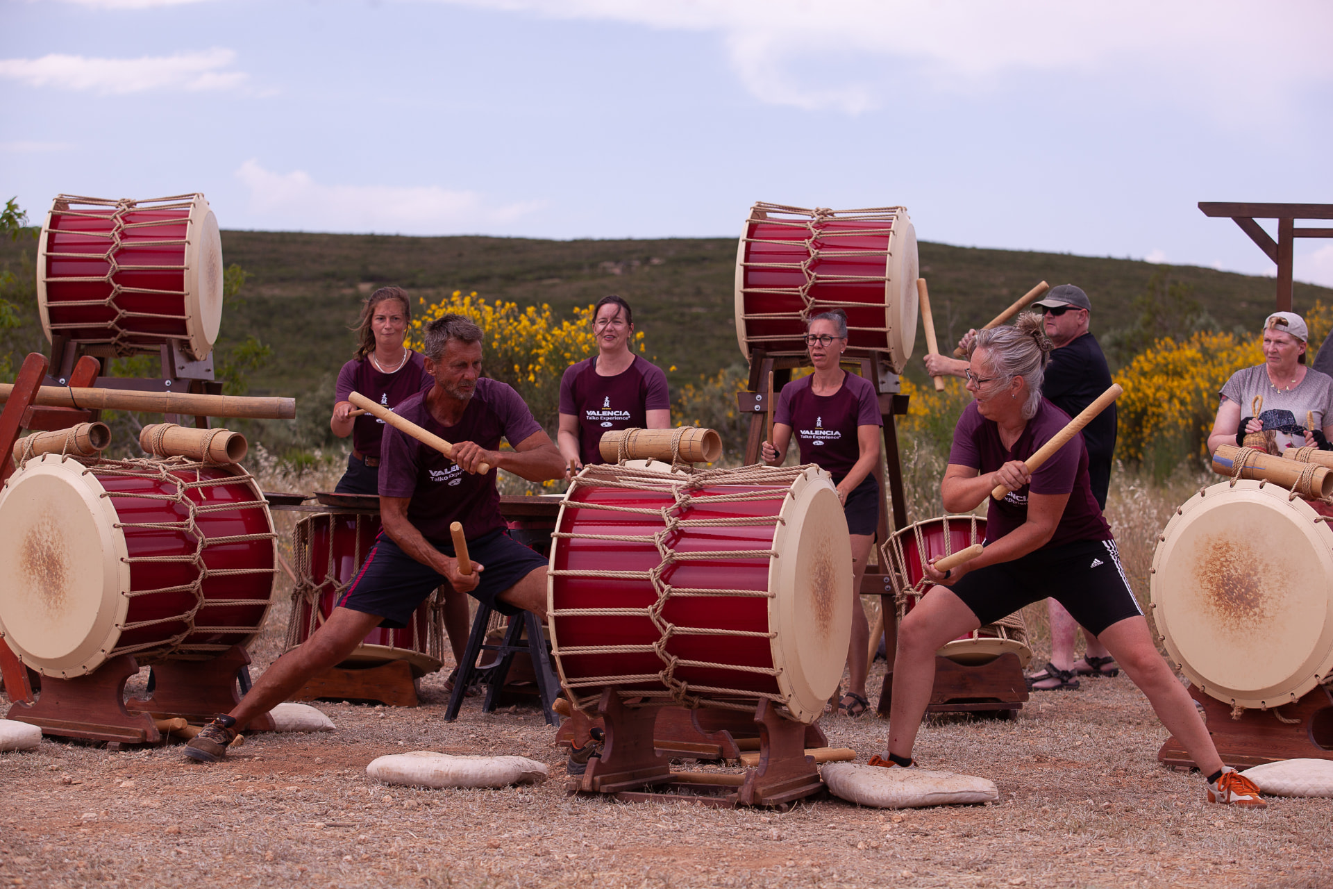 The group playing taiko drums together at the campo